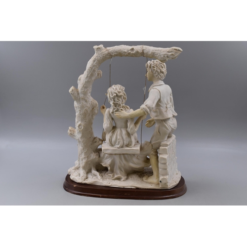 390 - Large Vintage Biscuit Porcelain Figurine entitled Swing Lovers Standing on Wooden Plinth (14