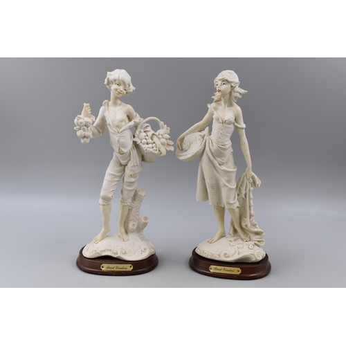 391 - Two Vintage Biscuit Porcelain Figures entitled Street Vendors standing on Wooden Plinths