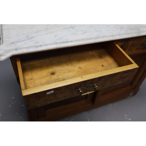 722 - Pine wash stand with two drawers and two cupboards on casters with brass fittings with a heavy marbl... 