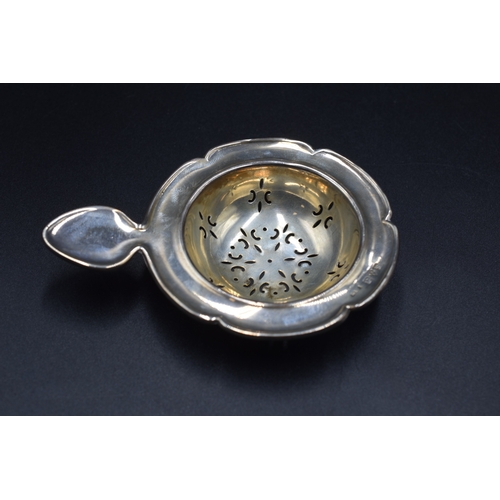 32 - A London Hallmarked Tea Strainer, circa 1970,s Maker Cooper Brothers and Sons Ltd (26 grams) and a C... 