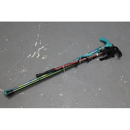 726 - Three metal adjustable walking sticks