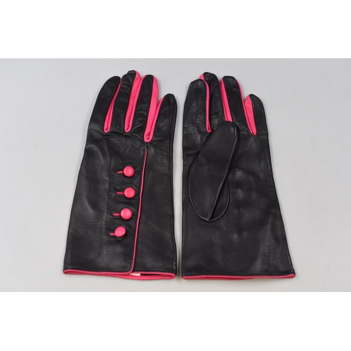 228 - Aspinal of London black leather gloves with pink buttons still in box size 8