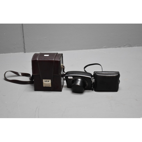 359 - 1 polaroid camera in case and a yashica camera with flash in case