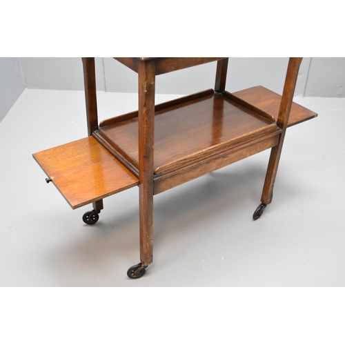 604 - Vintage dark wooden hostess/tea trolley on wheels with two slide out trays (32