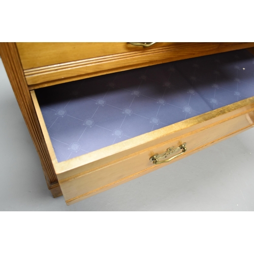 610 - Chest of four drawers in light wood with mirror and two extra small drawers at either side of the mi... 