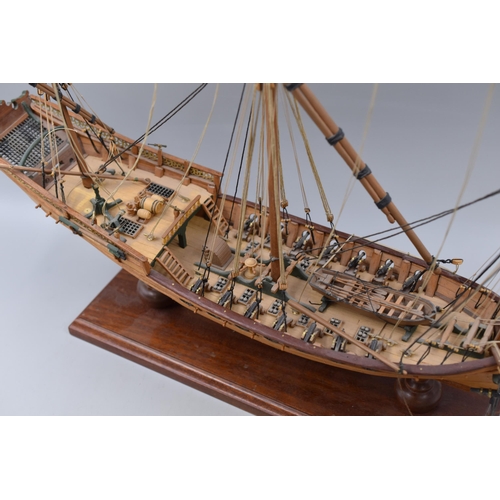 381 - Model of a three masted ship with cannon and lifeboat measuring 28