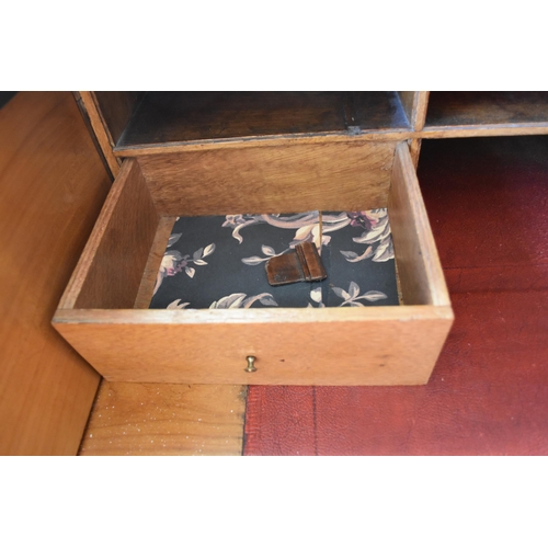 642 - Large light oak writing desk with seven front drawers with two internal drawers in the fold down top... 