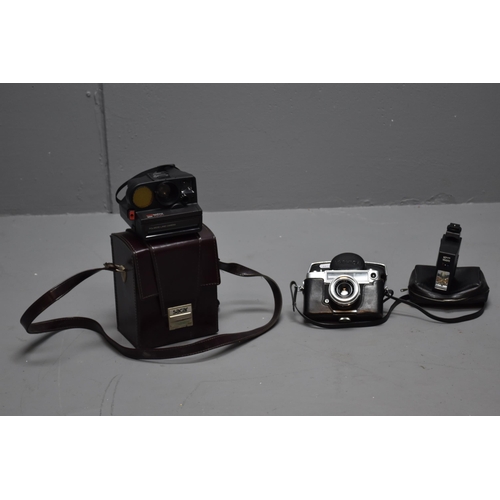 359 - 1 polaroid camera in case and a yashica camera with flash in case