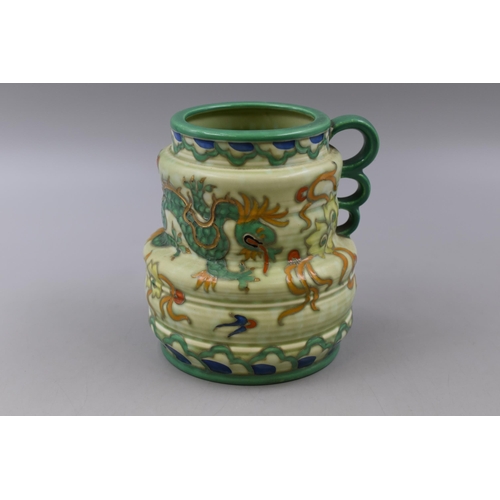 230 - A 1930's Charlotte Rhead for Crown Ducal Manchu Dragon pattern tankard decorated with a tubelined dr... 