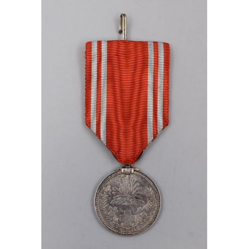 246 - A Japanese Red Cross Medal, With Ribbon. Possibly Silver