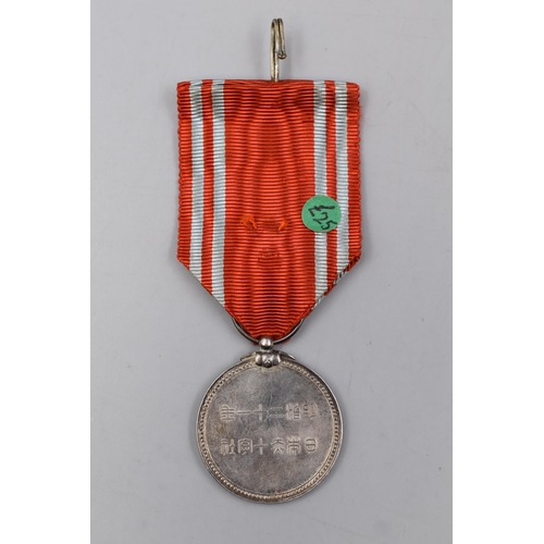 246 - A Japanese Red Cross Medal, With Ribbon. Possibly Silver