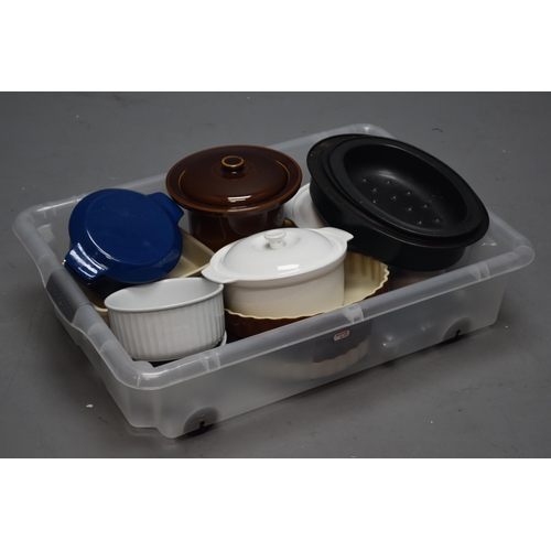 686 - Selection of kitchen items to include casseroles, flan dishes, serving dishes, small cast iron casse... 