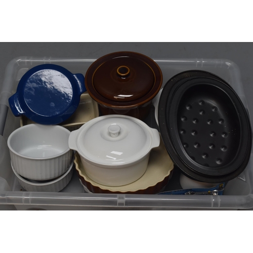 686 - Selection of kitchen items to include casseroles, flan dishes, serving dishes, small cast iron casse... 