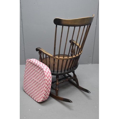 521 - An Antique Oak Windsor Spindle Backed Rocking Chair, With Handmade Floral Seat Cushion. Approx 104cm... 