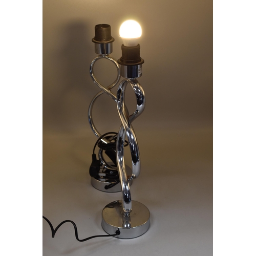 211 - A pair of chrome, switched stylised table lamps 18