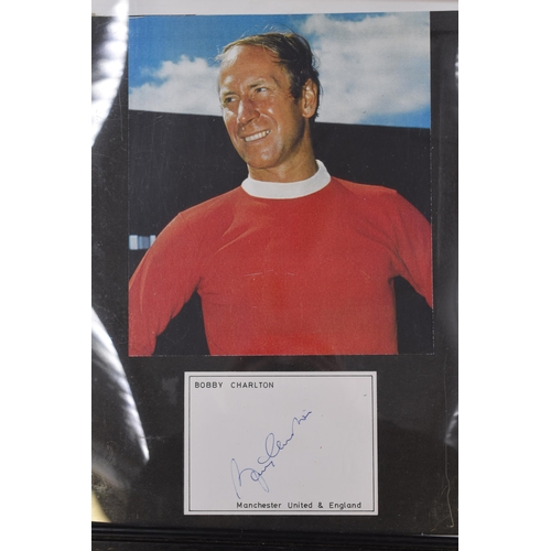 319 - A Framed and Glazed Signed Bobby Charlton Card, With Colour Photograph. Approx 34cm x 28cm. No Authe... 