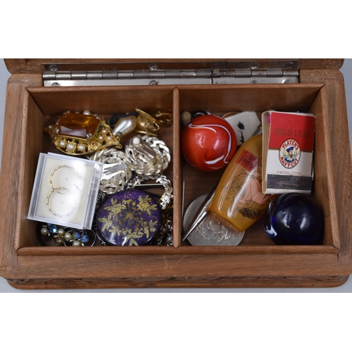 109 - A carved wooden jewellery box containing collectables and costume jewellery.