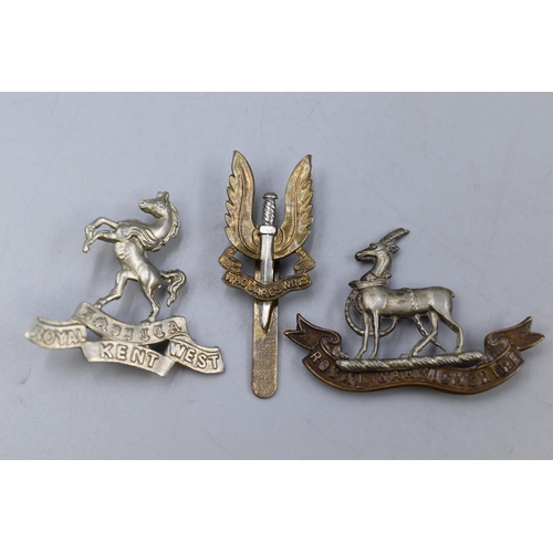 257 - Three Military Badges including Royal West Kent Regiment, SAS, and Royal Warwickshire Regiment