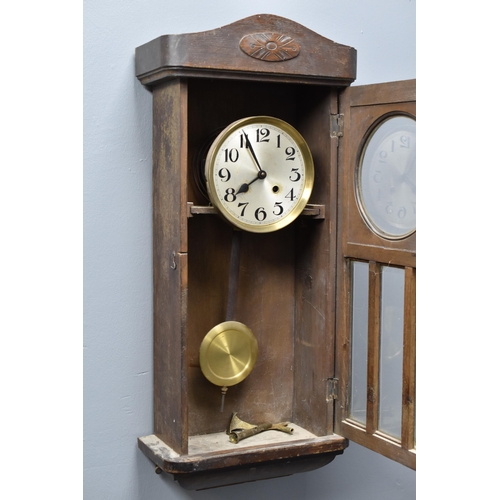 363 - 1930's oak cased wall clock with pendulum (32 x 13 x 6)