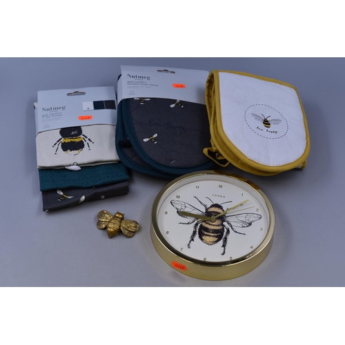 554 - A Selection of Bee Kitchen Items To Include Two Pairs of Oven Gloves, Tea Towel Set, And Wall Clock