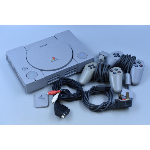 393 - A Sony PlayStation Console, With Two Controllers. Powers On When Tested