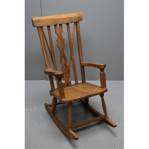 Vintage wheel backed carved rocking chair