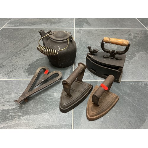 A Heavy Cast Iron Kettle, With Three Vintage Cast Iron Irons (Siddons, And Others), And Cast Iron Trivet