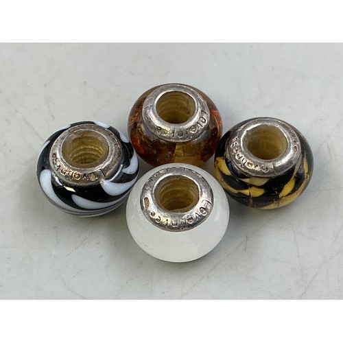 62 - Four 925. Silver Glass Bead Charms