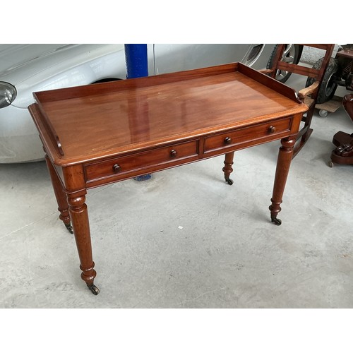 A 19th century Victorian mahogany writing table with a raised three ...