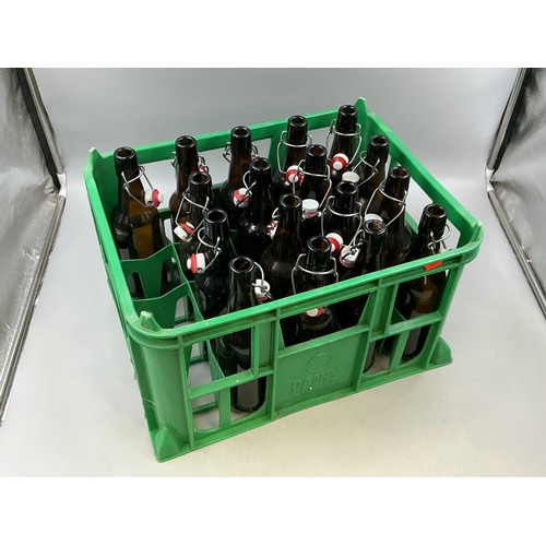 813 - Seventeen Brown Glass Swing Top Bottles, In Bottle Crate. Bottles Are Approx 26cm Tall