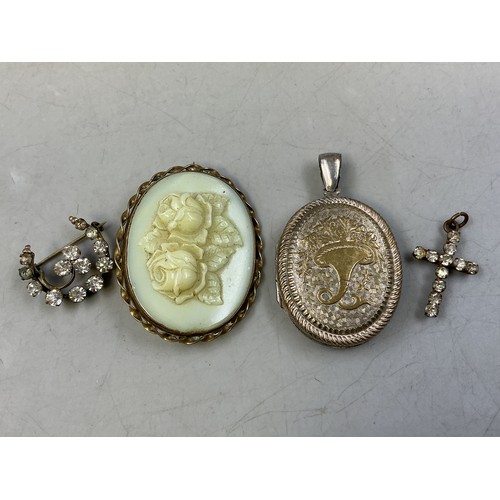 39 - Four Pieces of Antique Jewellery includes two Brooches, Locket Pendant and a Jewelled Cross