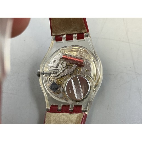 104 - A Ladies Swiss Swatch Quartz Watch, In Presentation Box - Brushed Metal Dial, Transparent Case, And ... 