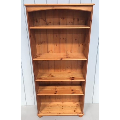 91 - A tall, open, Pine bookcase. 5 shelves and sits on bun feet.
Dimensions(cm) H167 W76 D28