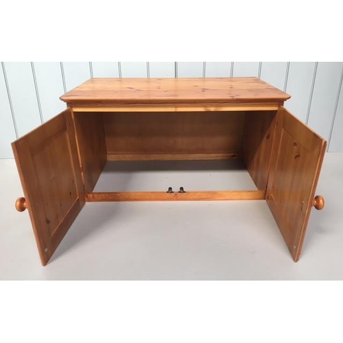 88 - A small pine unit made to sit upon another piece of furniture. 2-door with a hollow base.
Dimensions... 