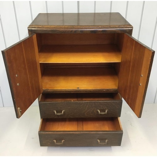 105 - A standard oak Tallboy. Single-shelved 2-door cupboard over 2 full width drawers.
Dimensions(cm) H 1... 