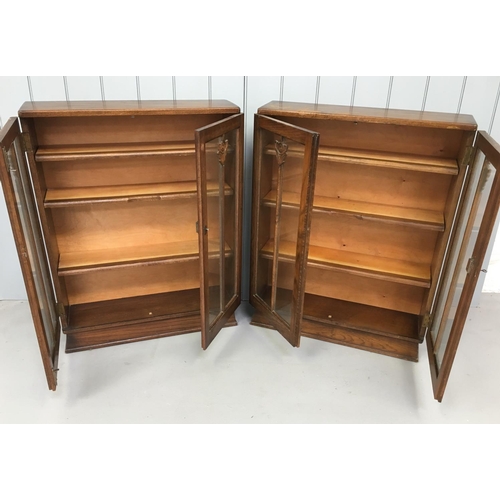 110 - A pair of matching half-height Oak Display Bookcases.
Both have decorative glazed doors and 3 shelve... 
