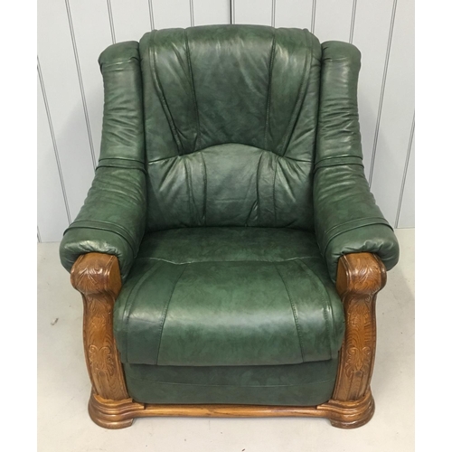 98 - A quality green leather suite, with oak surround. A two seater sofa and two armchairs. Each is a rec... 