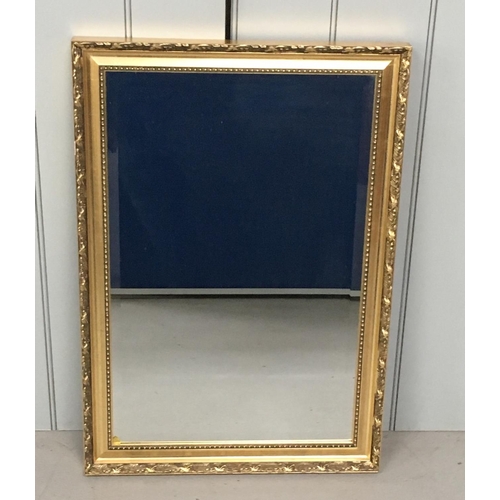 44 - A modern, ornate framed, bevelled edged mirror.
Dimensions(cm) H75 W52 D4