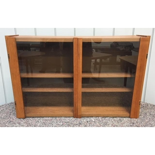 75 - A mid-century teak wall-hanging bookshelf. Complete with glass doors and wall bracket.
Dimensions(cm... 