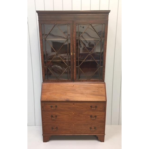 24 - A glass double-door bookcase over a bureau, with three drawers.
Key present.
Dimensions(cm) H 203 W1... 