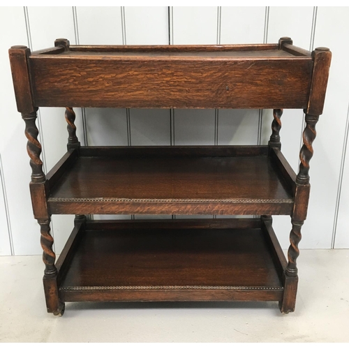 139 - A lovely oak tea trolley. Half-way height shelf with barley-twist supports, on castors.
Dimensions(c... 