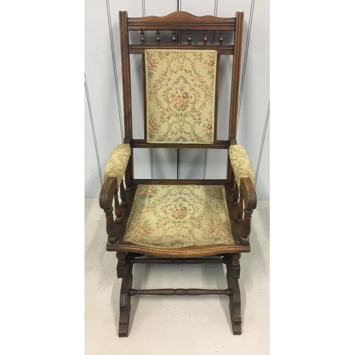 176 - A Victorian Oak American style rocking chair. Appears to be in original upholstery.
Dimensions(cm) H... 