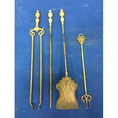12 - A set of Brass fire tools. Includes fork, tongs, poker and shovel.
