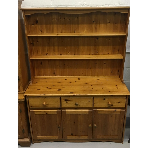 34 - A narrow pine dresser. 2 plate rack shelves over triples drawers/cupboards.
Dimensions(cm) H 182 W13... 