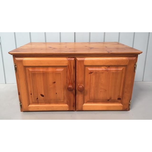 88 - A small pine unit made to sit upon another piece of furniture. 2-door with a hollow base.
Dimensions... 