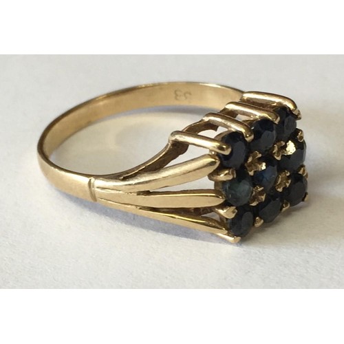 341 - A 9ct Gold ring with centre sapphire cluster. c.1978.
Size Q.