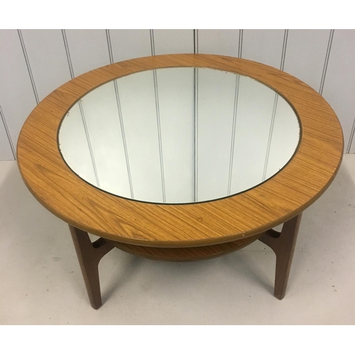 189 - A retro, circular coffee table. Centre table houses mirrored glass.
Dimensions(cm) H46 W84 D84