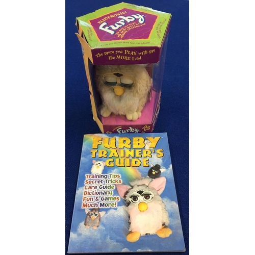 215 - A boxed, original 1998 Furby, together with a Trainer's guide book. Reference 70-800. Beige/Cream co... 