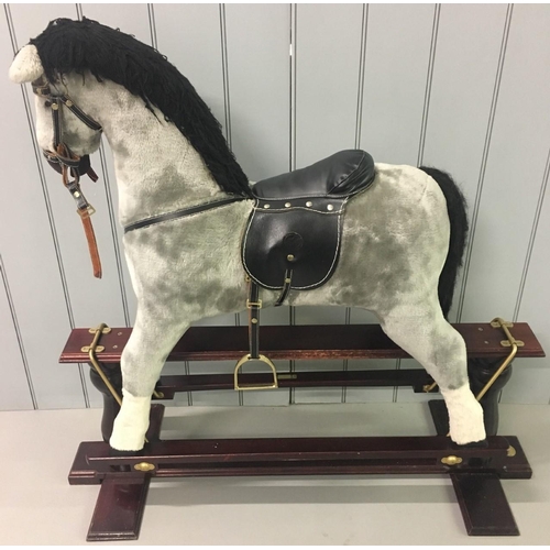 253 - A vintage cushioned rocking horse. 