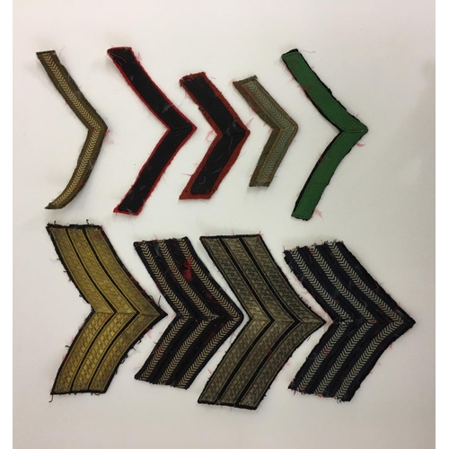 307 - A large collection of 9 Dress Stripes, 38 Trade/Cloth Badges, 4 Hackles & a Dress Cord